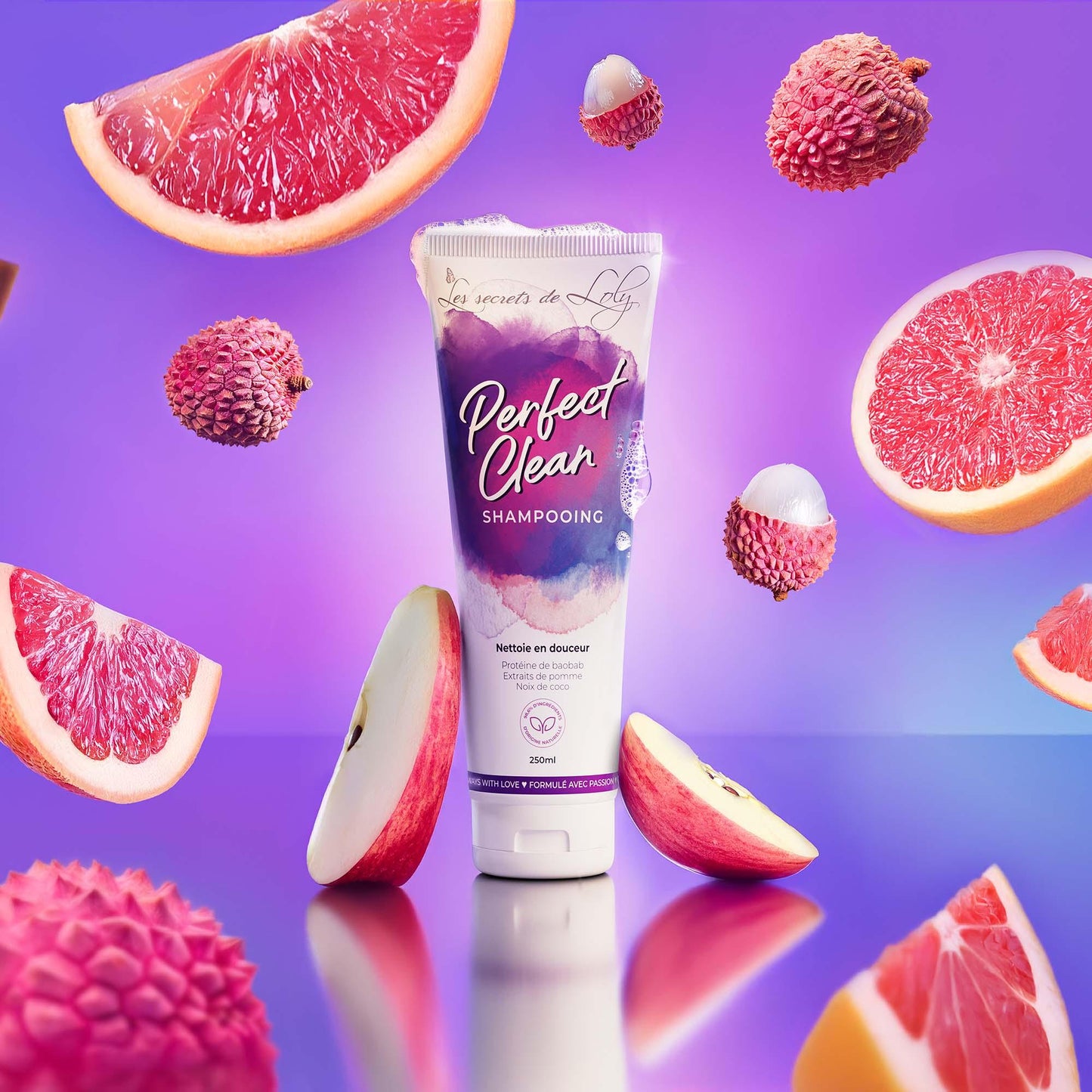 Perfect Clean Shampooing tube with grapefruit, lychee, and apple on a purple background