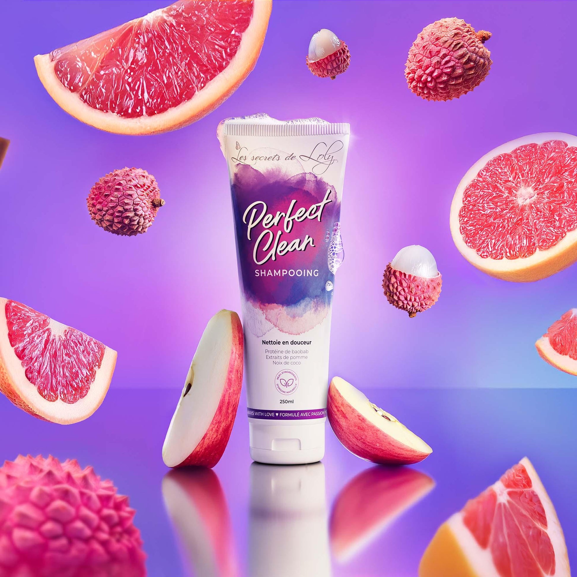 Perfect Clean Shampooing tube with grapefruit, lychee, and apple on a purple background