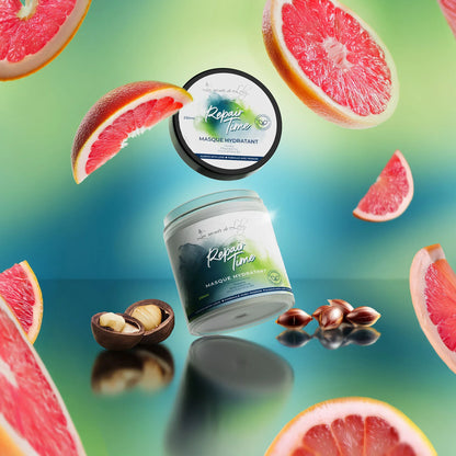 Hydrating hair mask jars with grapefruit slices and nuts on a vibrant background