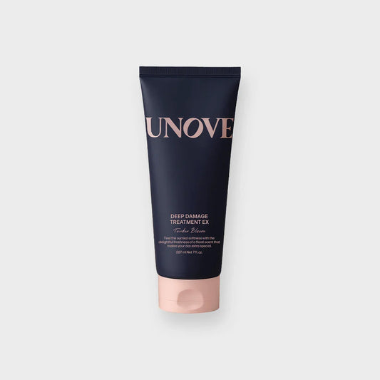 UNOVE Deep Damage Treatment EX hair care tube with pink cap on white background