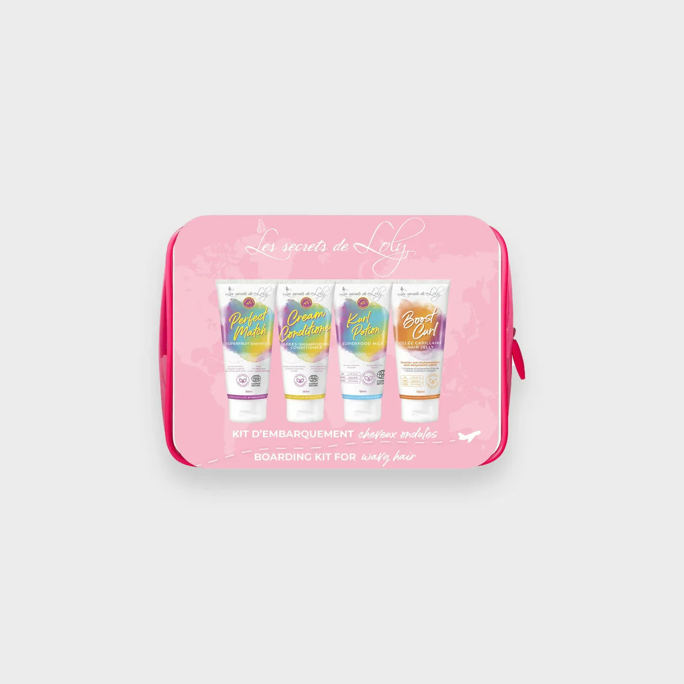 Wavy hair care travel kit with four colorful hair product tubes in a pink pouch