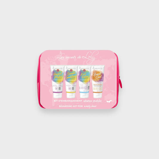 Wavy hair care travel kit with four colorful hair product tubes in a pink pouch